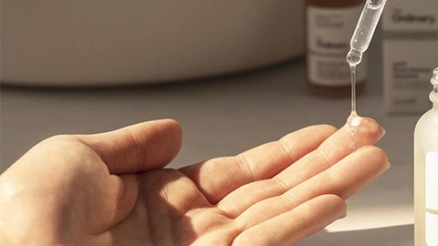 Pinzette trägt Azelainsäure auf Fingerspitze auf