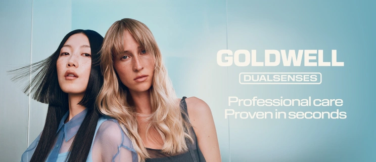 Reklama Goldwell Dualsenses przedstawiająca dwie kobiety (o czarnych i blond włosach) na niebieskim tle. Tekst: „GOLDWELL DUALSENSES Professional care – Sprawdzona skuteczność w kilka sekund”.